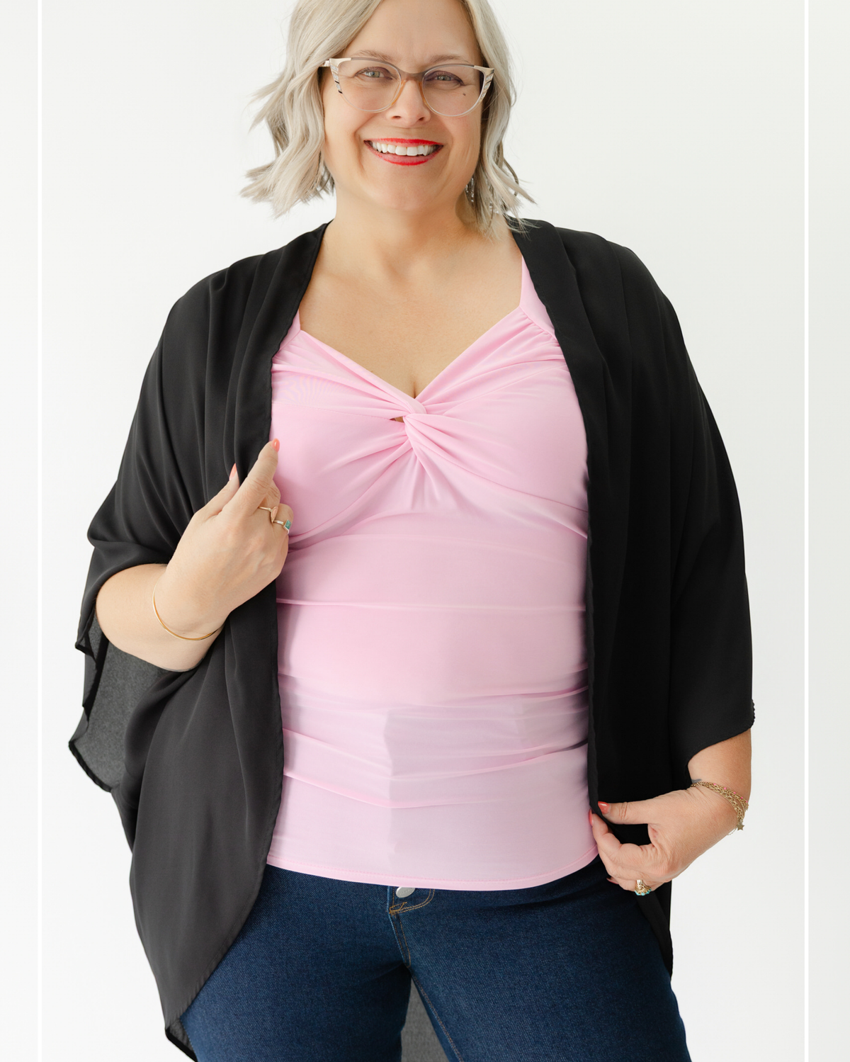 Woman wearing a pink top and black cardigan on a white background | Model Photo - Tricia | Harlow + James Boutique | West Des Moines, IA