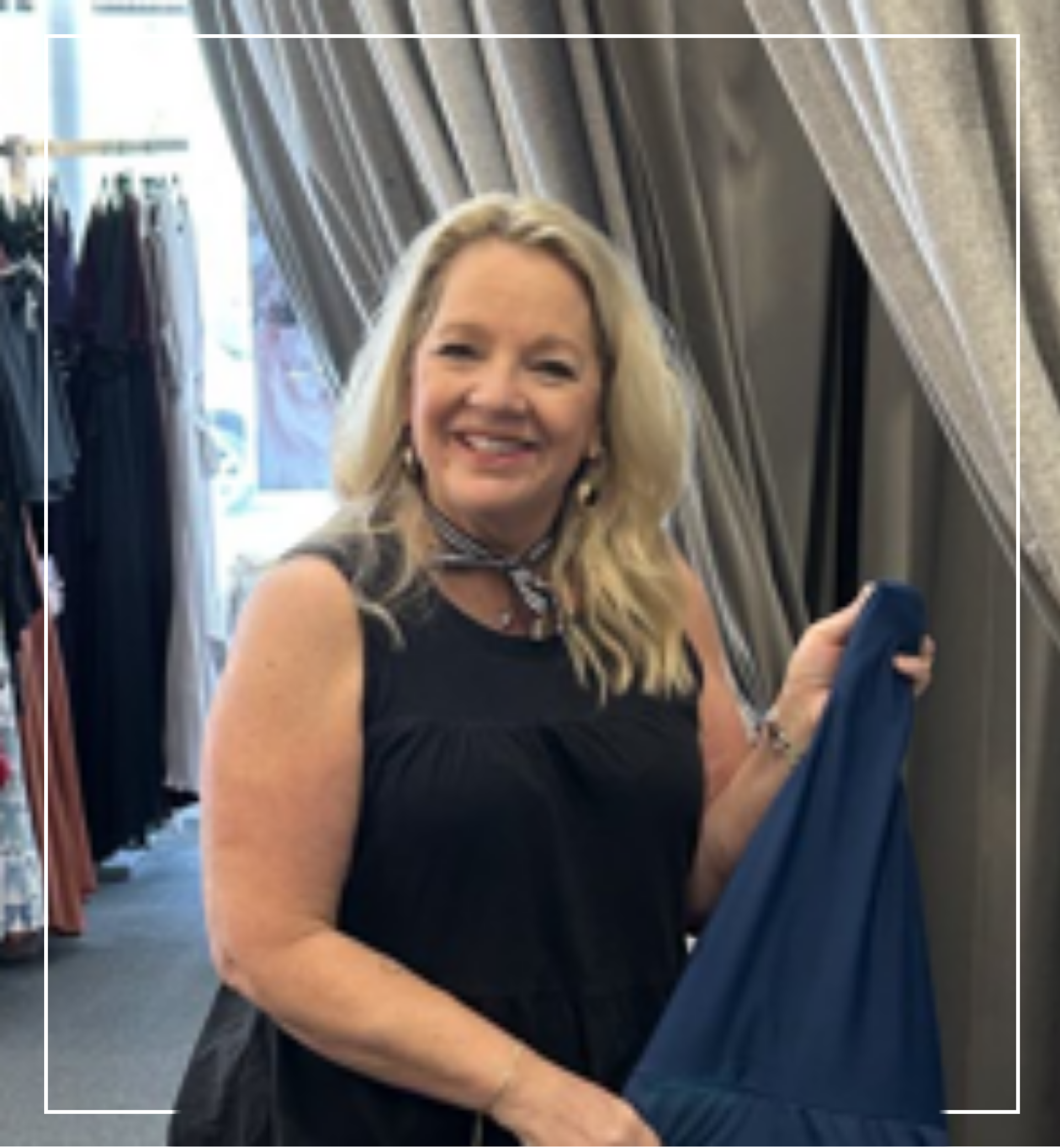 Woman holding a blue fabric in a clothing store | Staff - Tracey | Harlow + James Boutique | West Des Moines, IA
