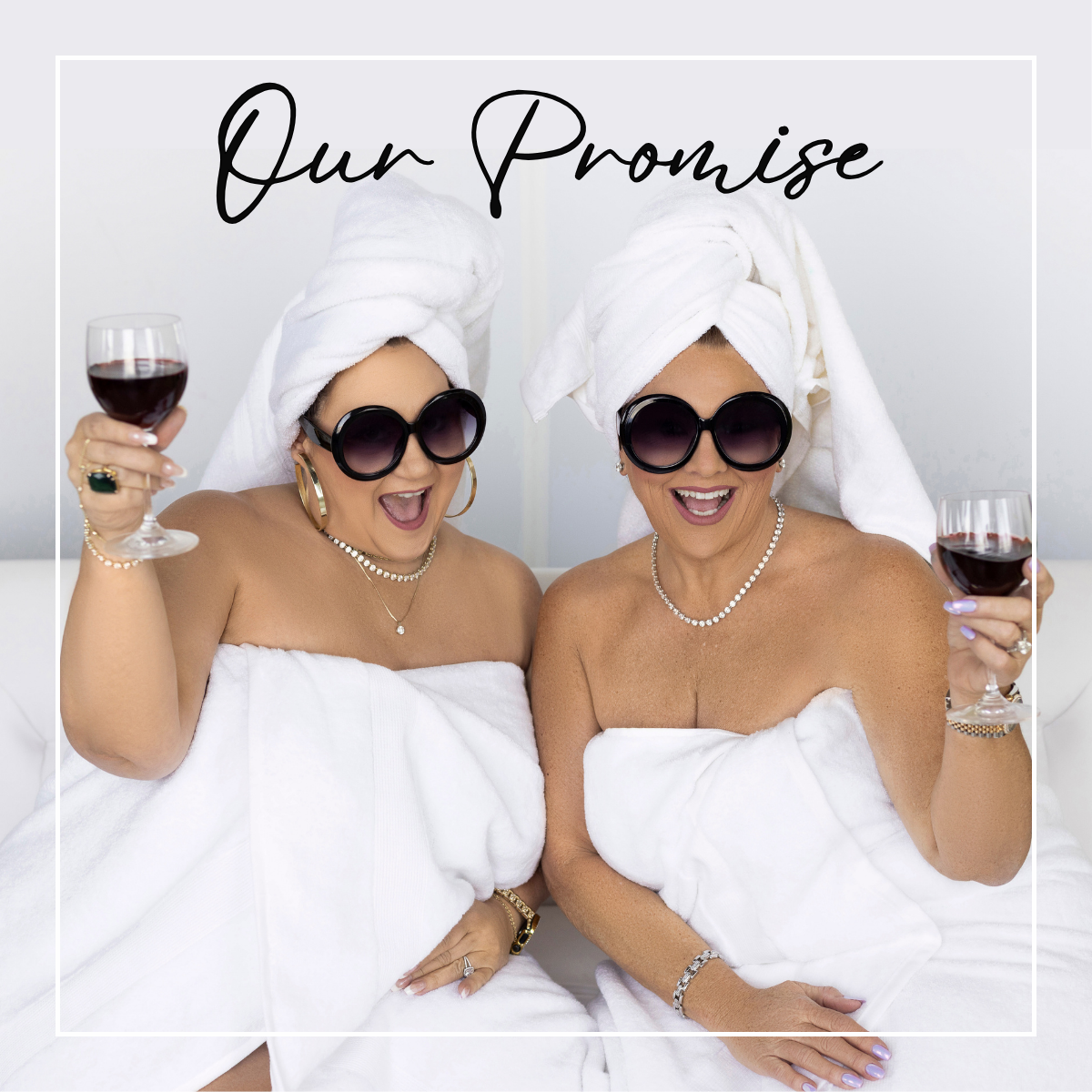 Two women wrapped in white towels with sunglasses, holding glasses of red wine, with 'Our Promise' text above | Harlow + James Boutique | West Des Moines, IA