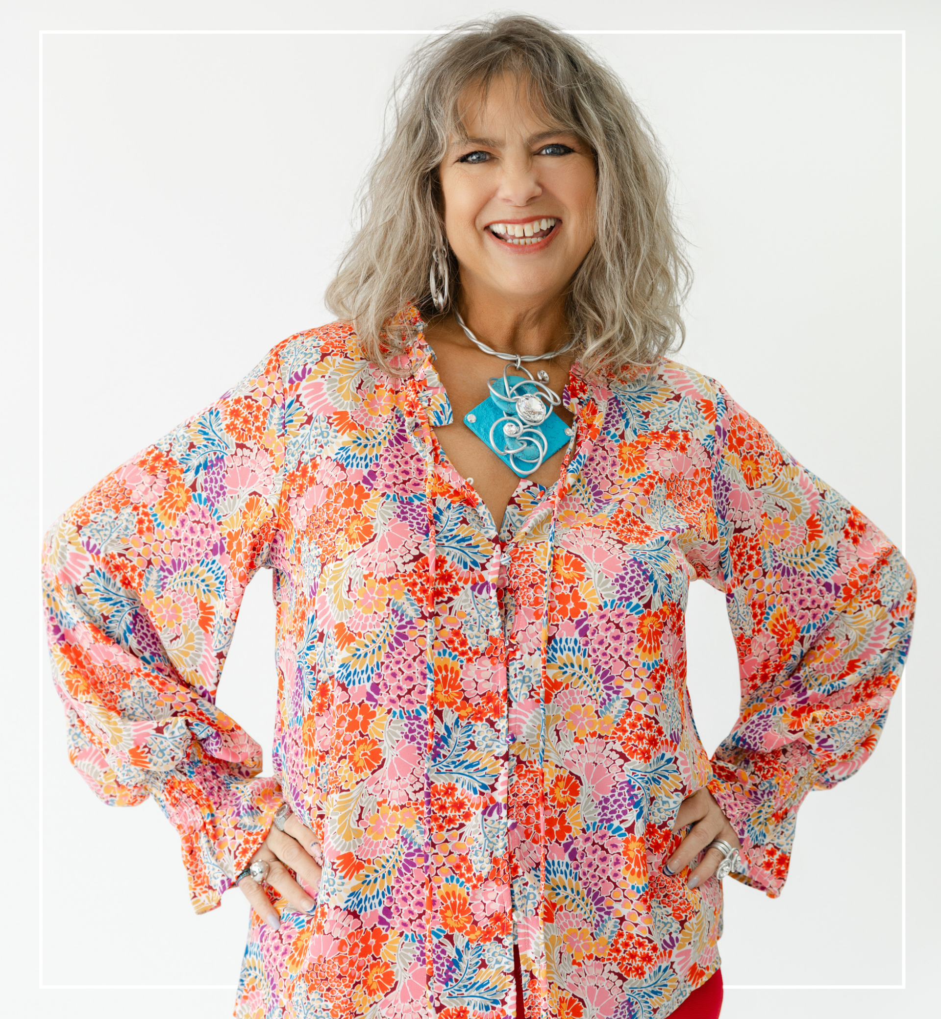 Woman wearing a colorful floral blouse with a white background | Staff - Trisha | Harlow + James Boutique | West Des Moines, IA